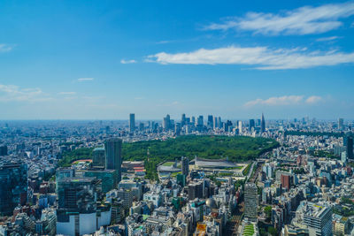 High angle view of city buildings against cloudy sky