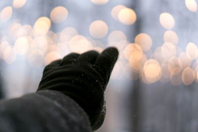 Low section of man against illuminated snow