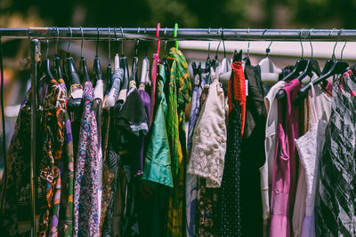 Close-up of multi colored clothes hanging on rack at market