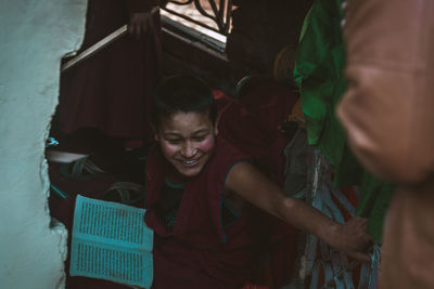 Rear view of a smiling girl with arms raised