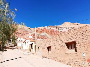 Low angle view of old building against blue sky