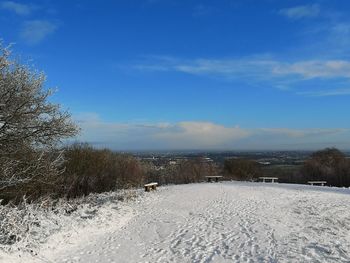 Scenic view of snow covered land against sky