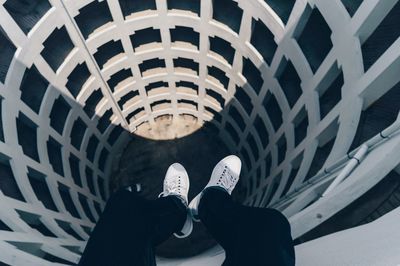 Low section of man relaxing on tower