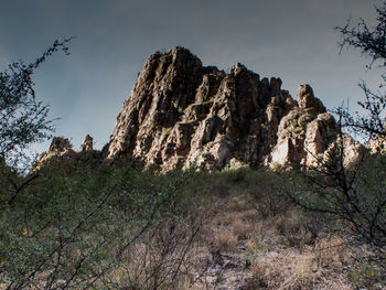 Low angle view of rock formations against sky