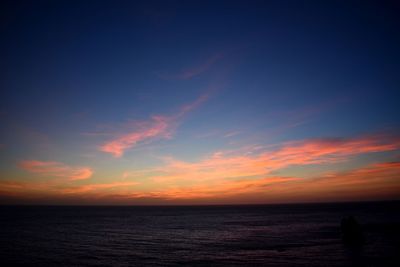 Scenic view of sea against romantic sky at sunset