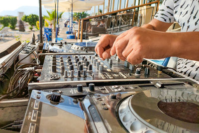 Turkey, alanya - august 12, 2022, dj play on dj console mixer on beach, hands and turntable close-up