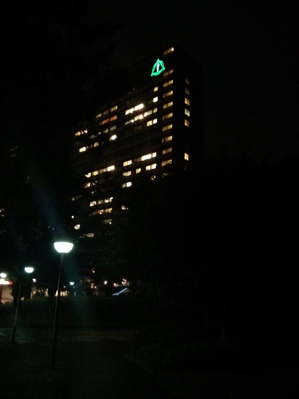 night, illuminated, building exterior, architecture, built structure, city, street light, street, lighting equipment, low angle view, building, clear sky, tall - high, dark, tower, skyscraper, modern, transportation, city life, sky