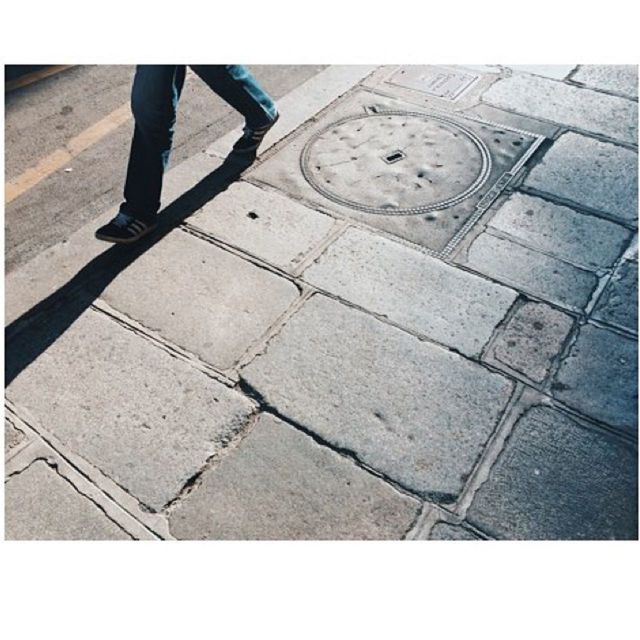 transfer print, low section, auto post production filter, lifestyles, men, person, leisure activity, walking, standing, shadow, street, unrecognizable person, cobblestone, paving stone, sunlight