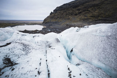 Scenic view of sea against sky during winter