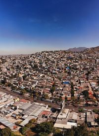 High angle view of townscape against blue sky