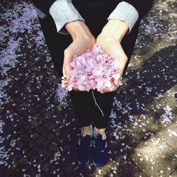 Close-up of woman holding white flowers