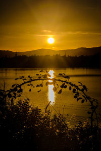 Scenic view of lake against sky during sunset