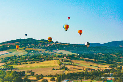 Hot air balloons flying over land