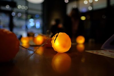 Close-up of illuminated lighting equipment on table at home during halloween
