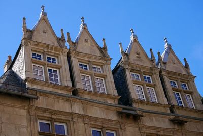 Low angle view of historical building against blue sky