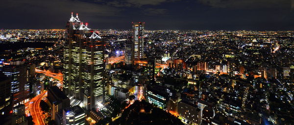 High angle view of illuminated city buildings at night