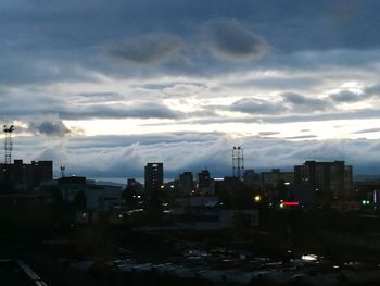 View of cityscape against cloudy sky