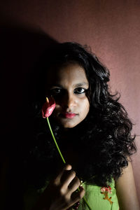 Portrait of woman holding flower