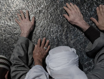 Close-up of men praying at mount arafat