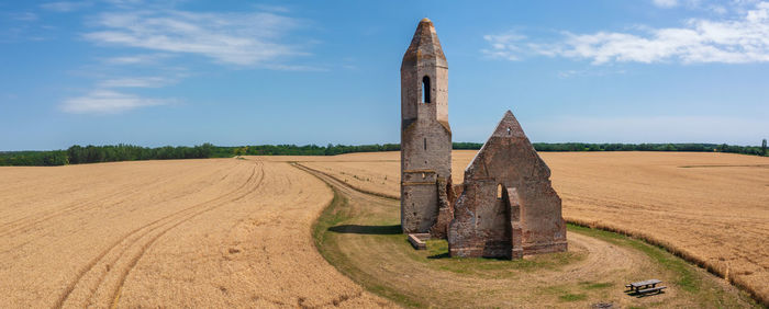 Aerial view about abandoned church ruin named pusztatemplom in the middle of an agricultural field.