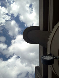 Low angle view of building against cloudy sky