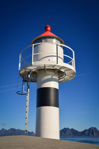 Low angle view of lighthouse against clear blue sky