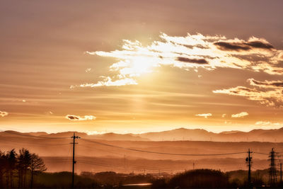 Scenic view of silhouette mountains against sky during sunset