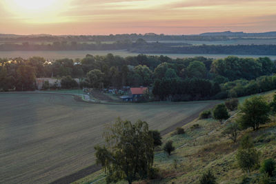 Scenic view of field against sky during sunset