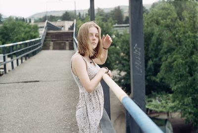 Woman standing on bridge