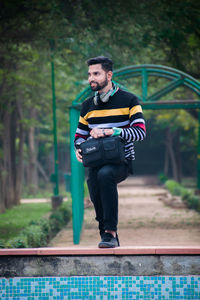 Portrait of man standing in park