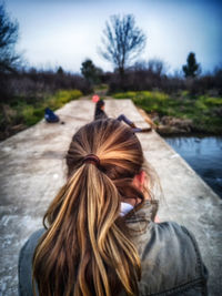 Rear view of friends against trees