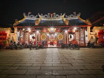 Group of people in illuminated building at night