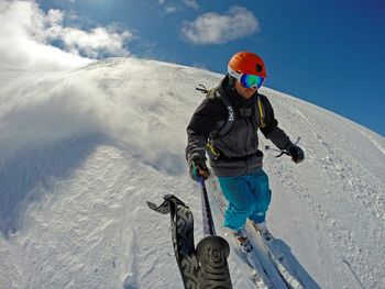 Woman skiing on snow covered landscape