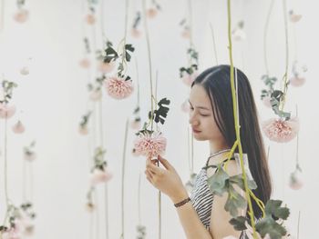 Young woman touching flowers