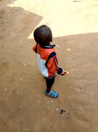 Rear view of boy standing on beach