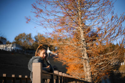 Portrait of young woman in park during winter