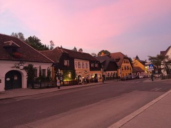 Houses by road against clear sky