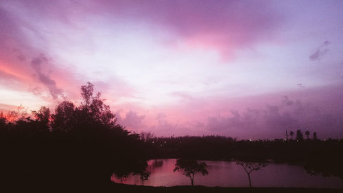 Scenic view of silhouette trees against sky at sunset