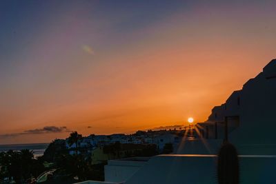 Silhouette buildings against sky during sunset