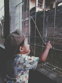 Cute girl looking through window