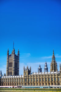 Buildings in city against blue sky