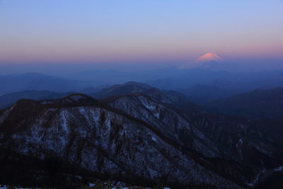 Scenic view of mountains against sky at sunset