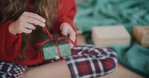 Midsection of woman holding gift