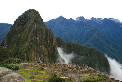 Scenic view of machu picchu against sky in foggy weather