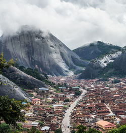 Aerial view of city against cloudy sky