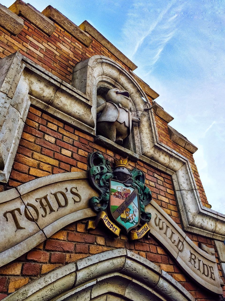 architecture, low angle view, building exterior, built structure, building, no people, sky, day, communication, text, representation, art and craft, nature, the past, history, outdoors, cloud - sky, sign, western script, human representation, ornate, carving