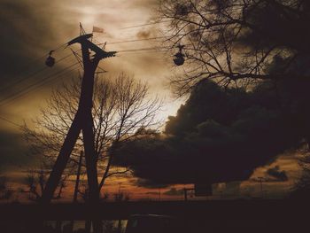 Low angle view of silhouette trees against sky