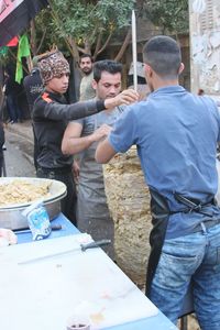 People standing by food