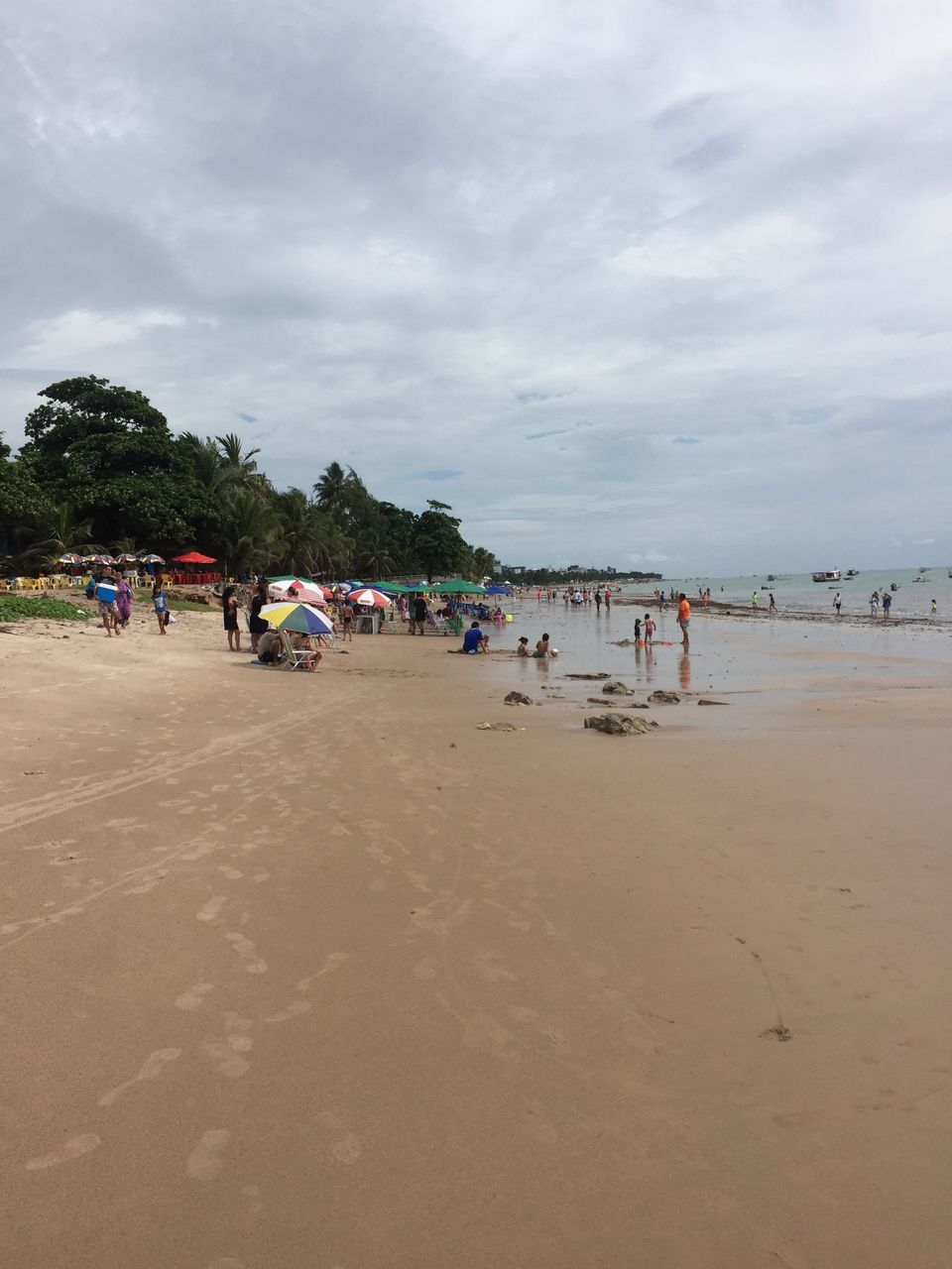 beach, sand, sky, large group of people, shore, cloud - sky, outdoors, real people, nature, day, sea, vacations, men, people