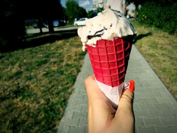 Close-up of hand holding ice cream